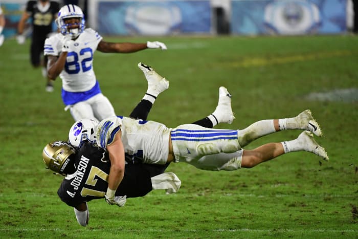 BYU linebacker Max Tooley makes a tackle against the UCF Knights in the Boca Raton Bowl.